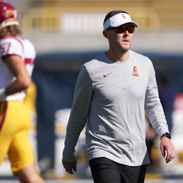 Oct 28, 2023; Berkeley, California, USA; USC Trojans head coach Lincoln Riley (center) walks on the field before the game against the California Golden Bears at California Memorial Stadium. Mandatory Credit: Darren Yamashita-Imagn Images
