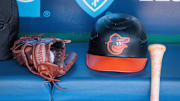 Apr 21, 2024; Kansas City, Missouri, USA; Baltimore Orioles hat and glove sits in the dugout during the ninth inning against the Kansas City Royals at Kauffman Stadium. Mandatory Credit: William Purnell-Imagn Images