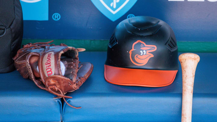 Apr 21, 2024; Kansas City, Missouri, USA; Baltimore Orioles hat and glove sits in the dugout during the ninth inning against the Kansas City Royals at Kauffman Stadium. 