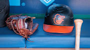 Apr 21, 2024; Kansas City, Missouri, USA; Baltimore Orioles hat and glove sits in the dugout during the ninth inning against the Kansas City Royals at Kauffman Stadium.