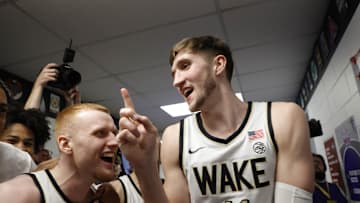 Mar 13, 2024; Washington, D.C., USA; Wake Forest Demon Deacons forward Andrew Carr (11) celebrates with Demon Deacons guard Cameron Hildreth (2) after placing the team sticker on the tournament drawsheet board after their game against the Notre Dame Fighting Irish at Capital One Arena. Mandatory Credit: Geoff Burke-Imagn Images