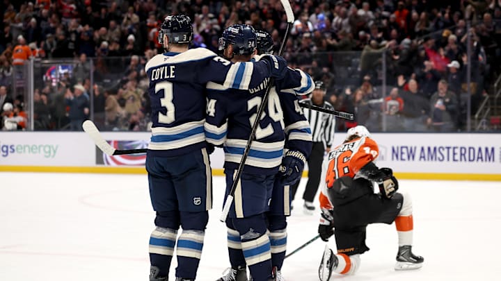 Blue Jackets forwards Charlie Coyle and Mathieu Olivier celebrate a goal against the Flyers.