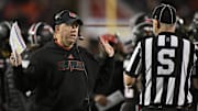 Nov 14, 2025; Louisville, Kentucky, USA;  Louisville Cardinals head coach Jeff Brohm talks with an official during the first half against the Clemson Tigers at L&N Federal Credit Union Stadium. Mandatory Credit: Jamie Rhodes-Imagn Images