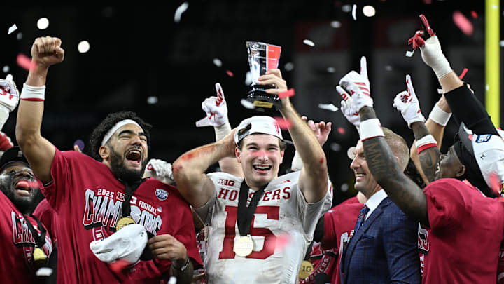 Indiana quarterback Fernando Mendoza celebrates with the MVP trophy after defeating Ohio State in the Big Ten championship game.