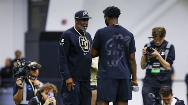 Apr 4, 2025; Boulder, CO, USA; Colorado Buffaloes head coach Deion Sanders talks to his son, Colorado Buffaloes quarterback S
