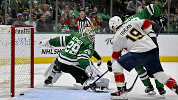 Mar 12, 2024; Dallas, Texas, USA; Florida Panthers left wing Matthew Tkachuk (19) watches as center Aleksander Barkov (not pictured) scores the game-winning goal against Dallas Stars goaltender Jake Oettinger (29) during the third period at the American Airlines Center. Mandatory Credit: Jerome Miron-Imagn Images
