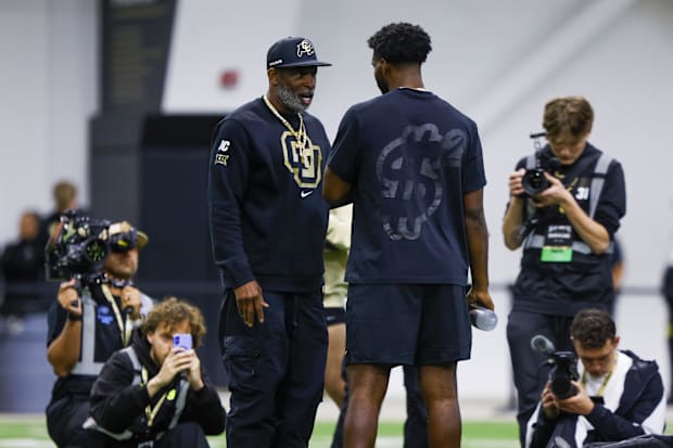 Apr 4, 2025; Boulder, CO, USA; Colorado Buffaloes head coach Deion Sanders talks to his son, Colorado Buffaloes quarterback S