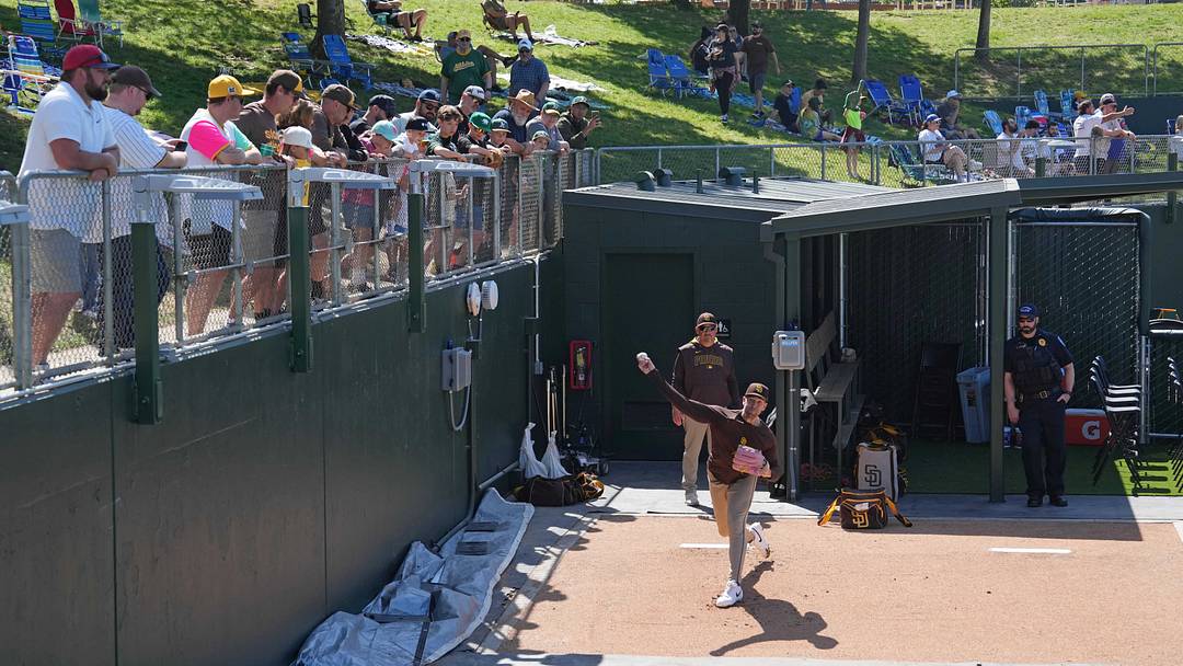 Fans watch from the right field lawn area as San Diego Padres pitcher Jason Adam (lower right) warms up in the bullpen before the game against the Athletics at Sutter Health Park on April 9, 2025. Fans watch from the right field lawn area as San Diego Padres pitcher Jason Adam (lower right) warms up in the bullpen before the game against the Athletics at Sutter Health Park on April 9, 2025.