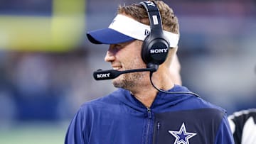 Aug 22, 2025; Arlington, Texas, USA; Dallas Cowboys head coach Brian Schottenheimer smiles during the first quarter against the Atlanta Falcons at AT&T Stadium. Mandatory Credit: Andrew Dieb-Imagn Images