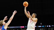 Houston Cougars guard Milos Uzan (7) shoots the ball against Florida Gators forward Thomas Haugh (10) during the first half of the national championship game of the Final Four of the 2025 NCAA Tournament at the Alamodome.