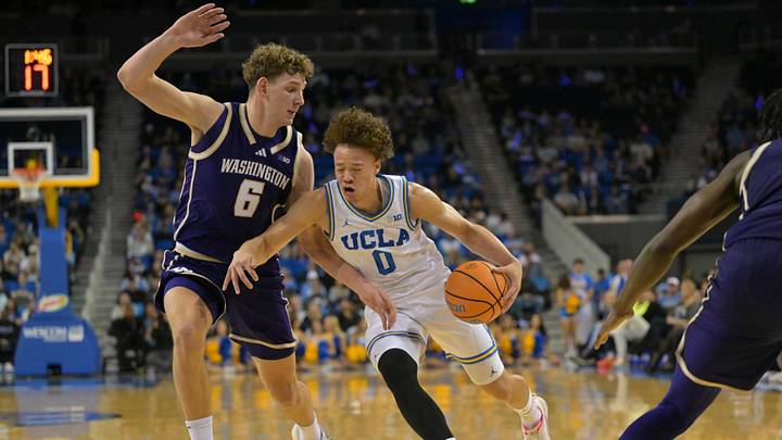 Feb 7, 2026; Los Angeles, California, USA;  UCLA Bruins guard Trent Perry (0) is defended by Washington Huskies forward Hannes Steinbach (6) as he drives to the basket in the first half at Pauley Pavilion presented by Wescom Financial. Mandatory Credit: Jayne Kamin-Oncea-Imagn Images