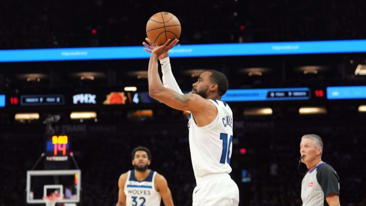 Apr 28, 2024; Phoenix, Arizona, USA; Minnesota Timberwolves guard Mike Conley (10) shoots against the Phoenix Suns during the first half of game four of the first round for the 2024 NBA playoffs at Footprint Center.