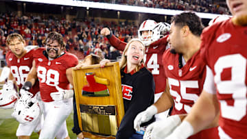 Nov 22, 2025; Stanford, California, USA; Stanford Cardinal players take possession of the axe after the game against the California Golden Bears at Stanford Stadium. Mandatory Credit: Sergio Estrada-Imagn Images