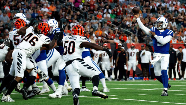 Colts quarterback Anthony Richardson (blue jersey; white pants/helmet) makes a throw behind his offensive line. 