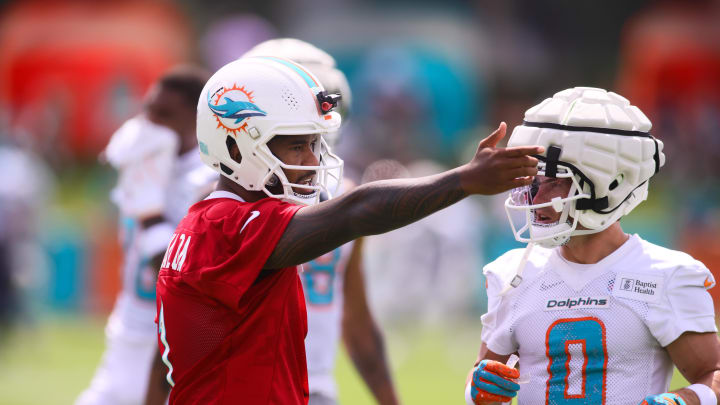 Jul 28, 2024; Miami Gardens, FL, USA; Miami Dolphins quarterback Tua Tagovailoa (1) signals during training camp at Baptist Health Training Complex.