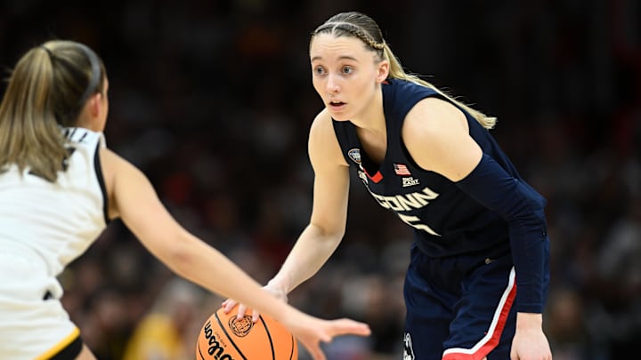 Apr 5, 2024; Cleveland, OH, USA; Connecticut Huskies guard Paige Bueckers (5) dribbles the ball against the Iowa Hawkeyes in the semifinals of the Final Four of the womens 2024 NCAA Tournament at Rocket Mortgage FieldHouse. Mandatory Credit: Ken Blaze-Imagn Images