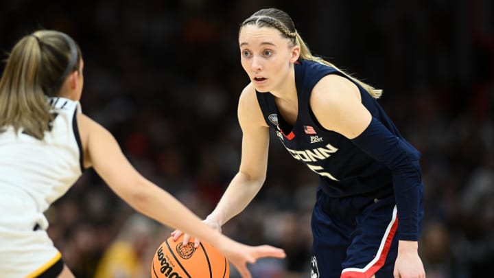 Apr 5, 2024; Cleveland, OH, USA; Connecticut Huskies guard Paige Bueckers (5) dribbles the ball against the Iowa Hawkeyes in the semifinals of the Final Four of the womens 2024 NCAA Tournament at Rocket Mortgage FieldHouse. Mandatory Credit: Ken Blaze-USA TODAY Sports