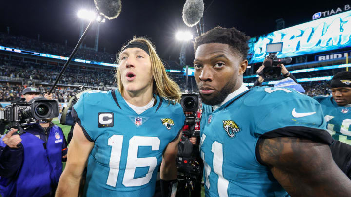 Jan 14, 2023; Jacksonville, Florida, USA; Jacksonville Jaguars quarterback Trevor Lawrence (16) and linebacker Josh Allen (41) celebrate after beating the Los Angeles Chargers in a wild card game at TIAA Bank Field. Mandatory Credit: Nathan Ray Seebeck-USA TODAY Sports