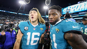 Jan 14, 2023; Jacksonville, Florida, USA; Jacksonville Jaguars quarterback Trevor Lawrence (16) and linebacker Josh Allen (41) celebrate after beating the Los Angeles Chargers in a wild card game at TIAA Bank Field. Mandatory Credit: Nathan Ray Seebeck-Imagn Images