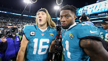 Jan 14, 2023; Jacksonville, Florida, USA; Jacksonville Jaguars quarterback Trevor Lawrence (16) and linebacker Josh Allen (41) celebrate after beating the Los Angeles Chargers in a wild card game at TIAA Bank Field. Mandatory Credit: Nathan Ray Seebeck-Imagn Images