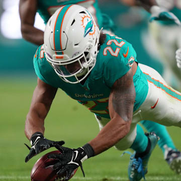 Miami Dolphins safety Elijah Campbell (22) recovers a muffed punt against the Tennessee Titans during the second half of an NFL game at Hard Rock Stadium in Miami Gardens, Dec. 11, 2023.