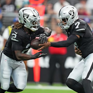 Nov 2, 2025; Paradise, Nevada, USA; Las Vegas Raiders quarterback Geno Smith (7) hands off the ball to Las Vegas Raiders running back Ashton Jeanty (2) during the first quarter against the Jacksonville Jaguars at Allegiant Stadium. Mandatory Credit: Kirby Lee-Imagn Images