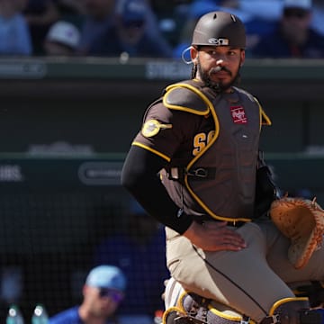Mar 4, 2025; Mesa, Arizona, USA; San Diego Padres catcher Luis Campusano (12) looks for a sign against the Chicago Cubs in the third inning at Sloan Park. Mandatory Credit: Rick Scuteri-Imagn Images
