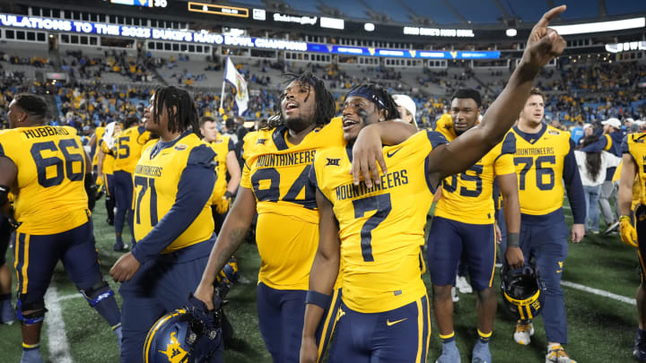 Dec 27, 2023; Charlotte, NC, USA;  West Virginia Mountaineers defensive lineman Hammond Russell IV (94) and wide receiver Trayvon Ray (7) after the game at Bank of America Stadium. Mandatory Credit: Bob Donnan-USA TODAY Sports