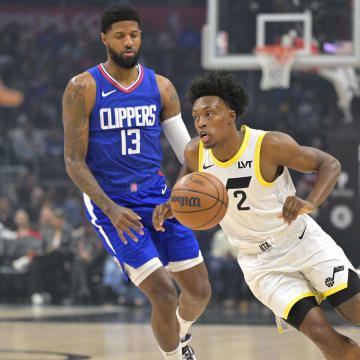 Apr 5, 2024; Los Angeles, California, USA; Utah Jazz guard Collin Sexton (2) takes the ball past Los Angeles Clippers forward Paul George (13) in the first half at Crypto.com Arena. Mandatory Credit: Jayne Kamin-Oncea-USA TODAY Sports