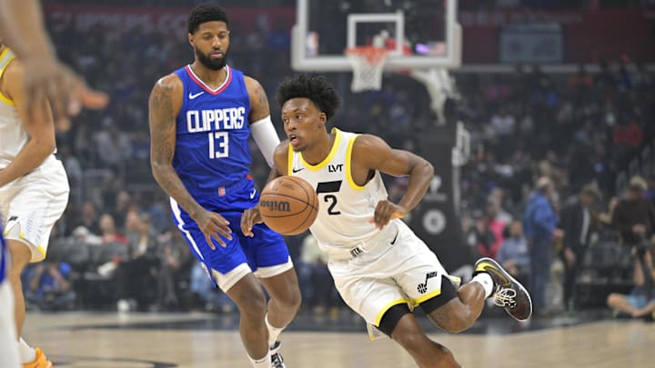 Apr 5, 2024; Los Angeles, California, USA; Utah Jazz guard Collin Sexton (2) takes the ball past Los Angeles Clippers forward Paul George (13) in the first half at Crypto.com Arena. Mandatory Credit: Jayne Kamin-Oncea-Imagn Images