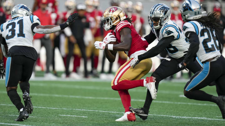 Oct 9, 2022; Charlotte, North Carolina, USA; San Francisco 49ers wide receiver Brandon Aiyuk (11) is tackled by Carolina Panthers cornerback Myles Hartsfield (38) and safety Juston Burris (31) during the second half at Bank of America Stadium. Mandatory Credit: Jim Dedmon-USA TODAY Sports