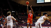 Dec 15, 2024; Blacksburg, Virginia, USA; Virginia Tech Hokies guard Ben Hammond (11) shoots the ball against Navy Midshipmen guard Austin Benigni (1) during the first half at Cassell Coliseum. Mandatory Credit: Peter Casey-Imagn Images