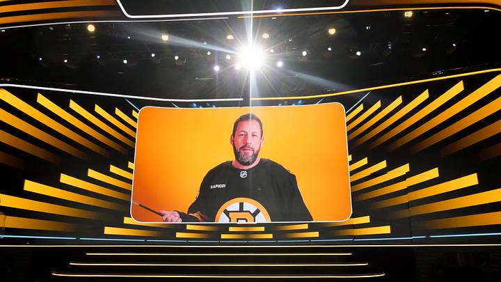 Jun 27, 2025; Los Angeles, California, USA; Adam Sandler announces the seventh overall pick for the Boston Bruins in the first round of the 2025 NHL Draft at Peacock Theater. Mandatory Credit: Kirby Lee-Imagn Images