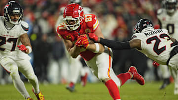 Jan 18, 2025; Kansas City, Missouri, USA; Kansas City Chiefs tight end Travis Kelce (87) runs after a pass reception against Houston Texans cornerback Myles Bryant (27) and safety Eric Murray (23) during the fourth quarter of a 2025 AFC divisional round game at GEHA Field at Arrowhead Stadium. Mandatory Credit: Jay Biggerstaff-Imagn Images