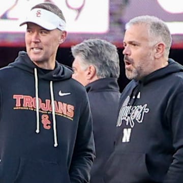 Nebraska coach Matt Rhule (right) talks with USC coach Lincoln Riley before Saturday night's game.