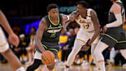 Apr 19, 2025; Los Angeles, California, USA; Minnesota Timberwolves guard Anthony Edwards (5) drives past Los Angeles Lakers forward Dorian Finney-Smith (17) in the second half at Crypto.com Arena. Mandatory Credit: Jayne Kamin-Oncea-Imagn Images