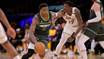 Apr 19, 2025; Los Angeles, California, USA; Minnesota Timberwolves guard Anthony Edwards (5) drives past Los Angeles Lakers forward Dorian Finney-Smith (17) in the second half at Crypto.com Arena. Mandatory Credit: Jayne Kamin-Oncea-Imagn Images