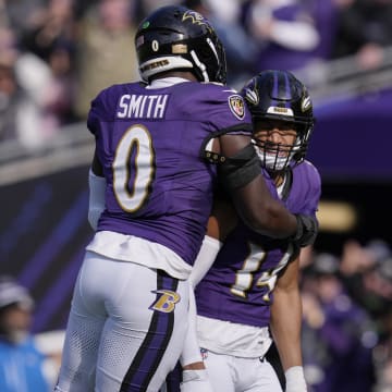 Nov 12, 2023; Baltimore, Maryland, USA; Baltimore Ravens safety Kyle Hamilton (14) celebrates with linebacker Roquan Smith (0) after scoring a touchdown against the Cleveland Browns during the first quarter at M&T Bank Stadium. Mandatory Credit: Jessica Rapfogel-USA TODAY Sports