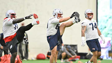 Jun 10, 2025; Foxborough, MA, USA; New England Patriots offensive tackle Mike Onwenu (71), guard Cole Strange (69) and offensive lineman Jack Conley (74) stretch during minicamp held in the WIN Field House at Gillette Stadium. Mandatory Credit: Eric Canha-Imagn Images