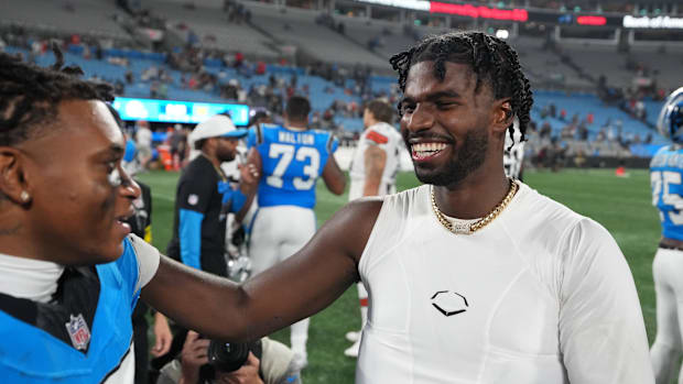Cleveland Browns quarterback Shedeur Sanders (12) with Carolina Panthers wide receiver Jimmy Horn Jr. (15) after the game at