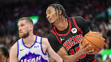 Nov 16, 2025; Salt Lake City, Utah, USA; Chicago Bulls forward Julian Phillips (15) makes a rebound against Utah Jazz guard/forward Svi Mykhailiuk (10) during the first half at Delta Center. Mandatory Credit: Peter Creveling-Imagn Images