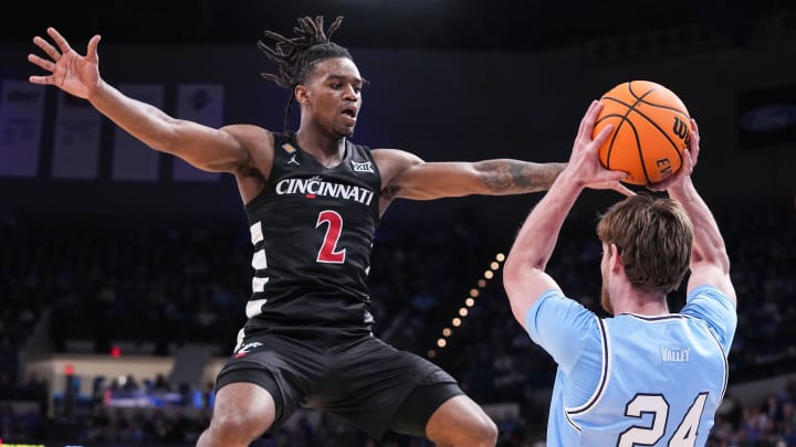 Indiana State Sycamores guard Jake Wolfe (24) searches to pass the ball against Cincinnati Bearcats guard Jizzle James (2) on Tuesday, March 26, 2024, during the quarterfinals of the NIT at the Hulman Center in Terre Haute.