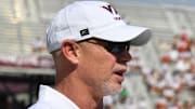 Sep 20, 2025; Blacksburg, Virginia, USA;  Virginia Tech Hokies head coach Phillip Montgomery and Wofford Terriers head coach Shawn Watson talk before the game 1at Lane Stadium. Mandatory Credit: Brian Bishop-Imagn Images