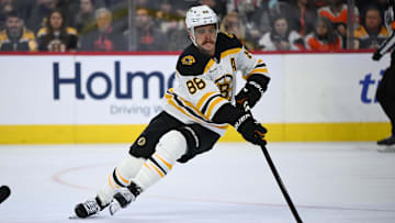 Nov 2, 2024; Philadelphia, Pennsylvania, USA; Boston Bruins right wing David Pastrnak (88) reaches for the puck against the Philadelphia Flyers in the second period at Wells Fargo Center. Mandatory Credit: Kyle Ross-Imagn Images