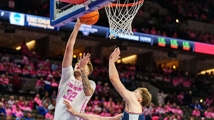 Jan 31, 2026; Omaha, Nebraska, USA; Creighton Bluejays forward Owen Freeman (32) shoots the ball against Connecticut Huskies guard Braylon Mullins (24) during the second half at CHI Health Center Omaha. Mandatory Credit: Dylan Widger-Imagn Images