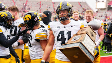 Nov 28, 2025; Lincoln, Nebraska, USA; Iowa Hawkeyes linebacker Jaden Harrell (41) holds the Heroes Trophy after defeating the Nebraska Cornhuskers at Memorial Stadium. Mandatory Credit: Dylan Widger-Imagn Images
