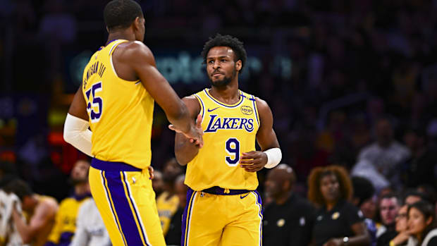 Apr 11, 2025; Los Angeles, California, USA; Los Angeles Lakers guard Bronny James Jr. (9) celebrates with center Trey Jemison