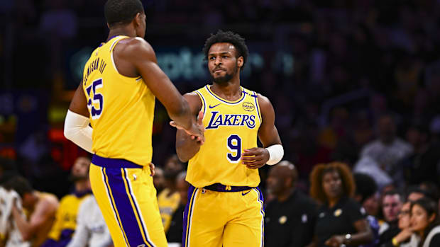 Apr 11, 2025; Los Angeles, California, USA; Los Angeles Lakers guard Bronny James Jr. (9) celebrates with center Trey Jemison