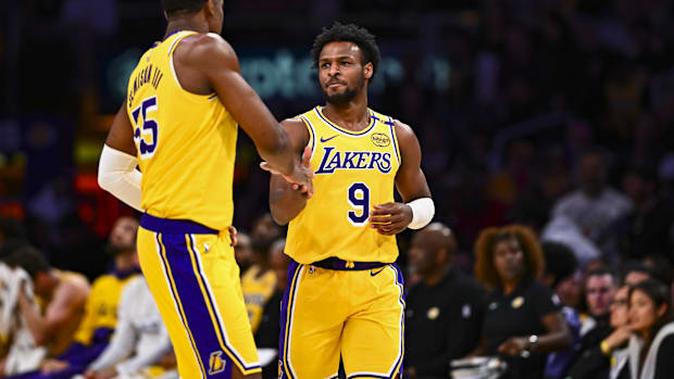 Los Angeles Lakers guard Bronny James Jr. (9) celebrates with center Trey Jemison III (55) after scoring against the Houston