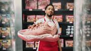 Tyrese Haliburton holds the PUMA Hali 1 'Hibiscus' colorway.